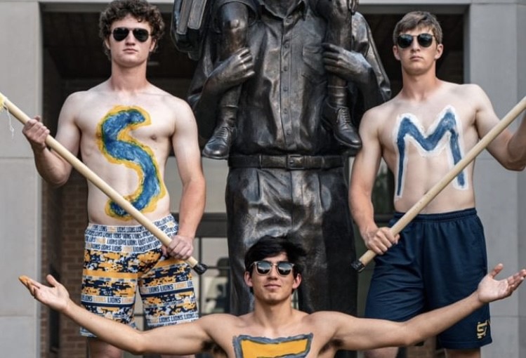 The Superfanmen in front of the statue