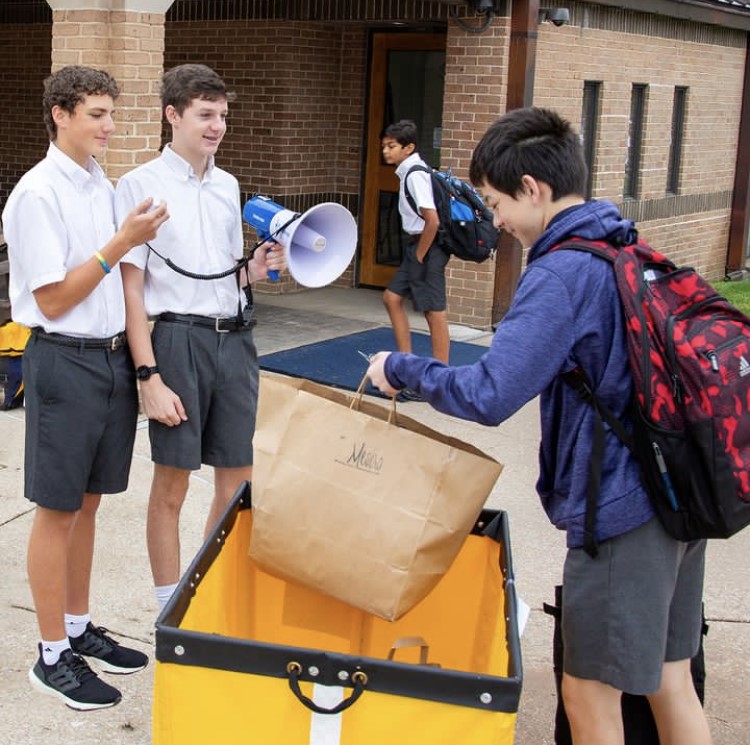 A student drops off clothes to be donated at the Clothing Drive.