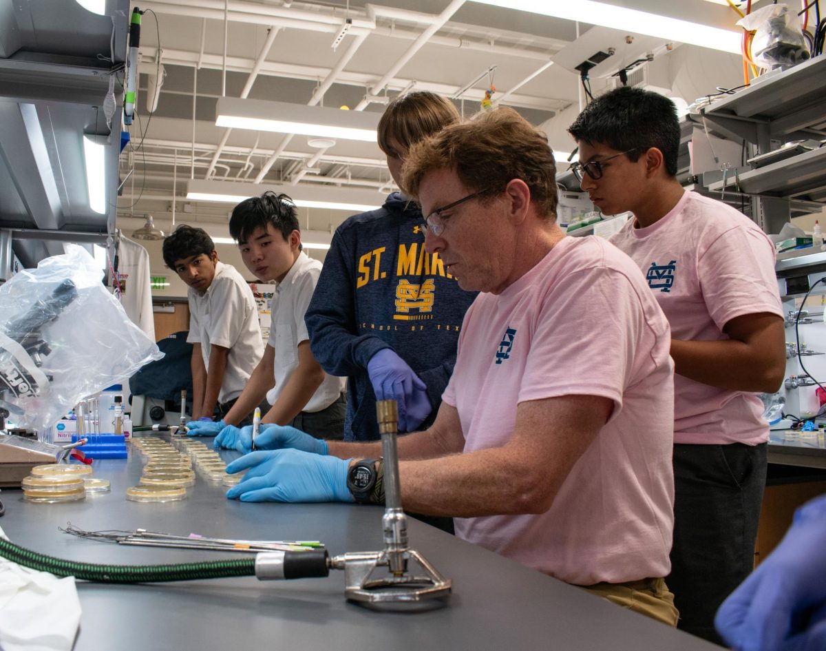 Biology club sponser Mark Adame showing students proper laboratory techniques