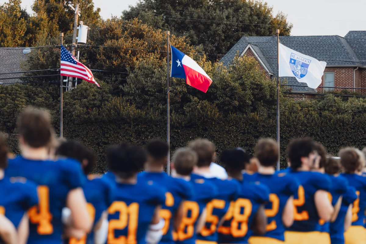 The team stands towards the American flag for the national anthem.