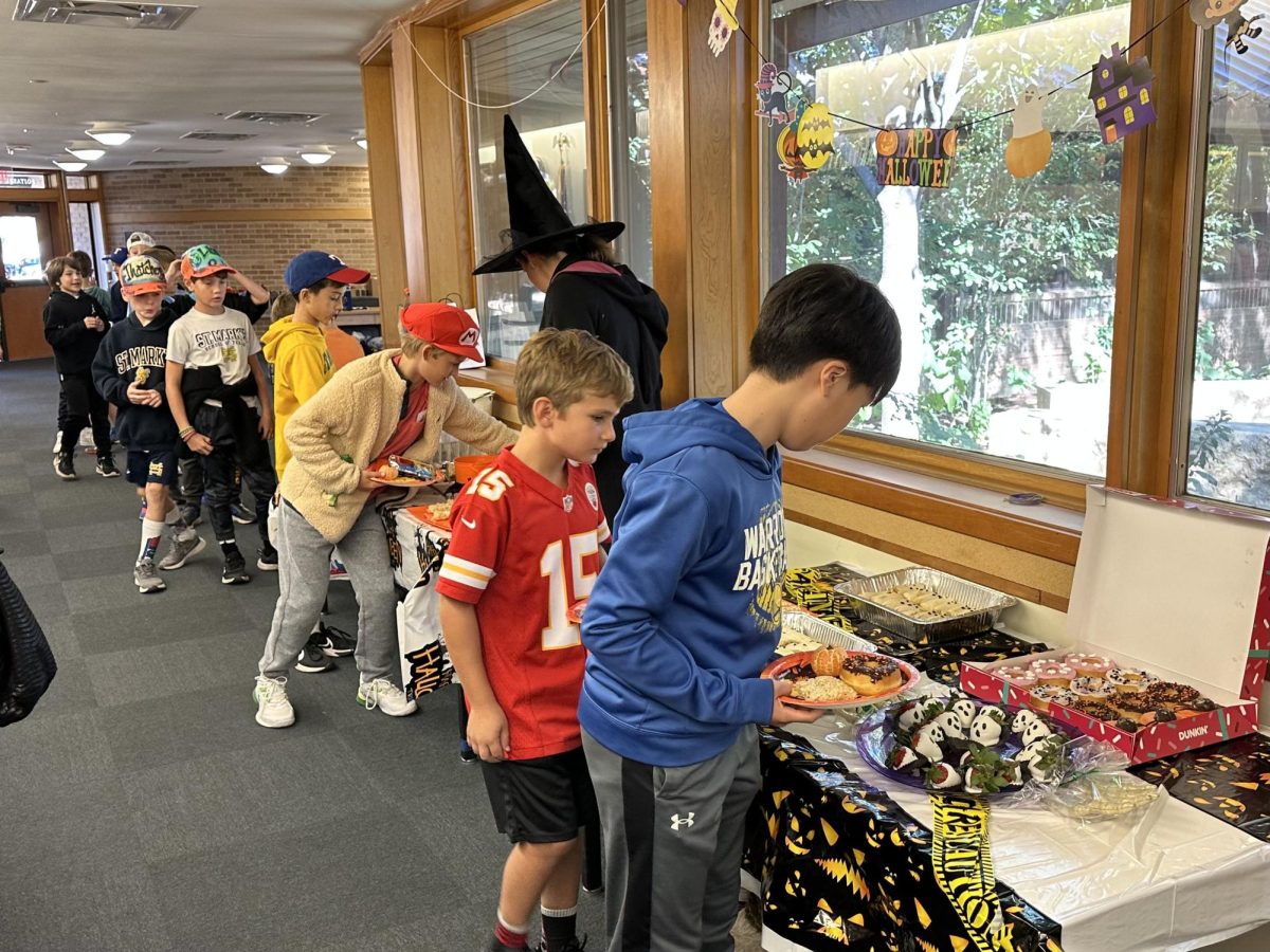 Lower school students carefully select which delicious sweet treats they want.