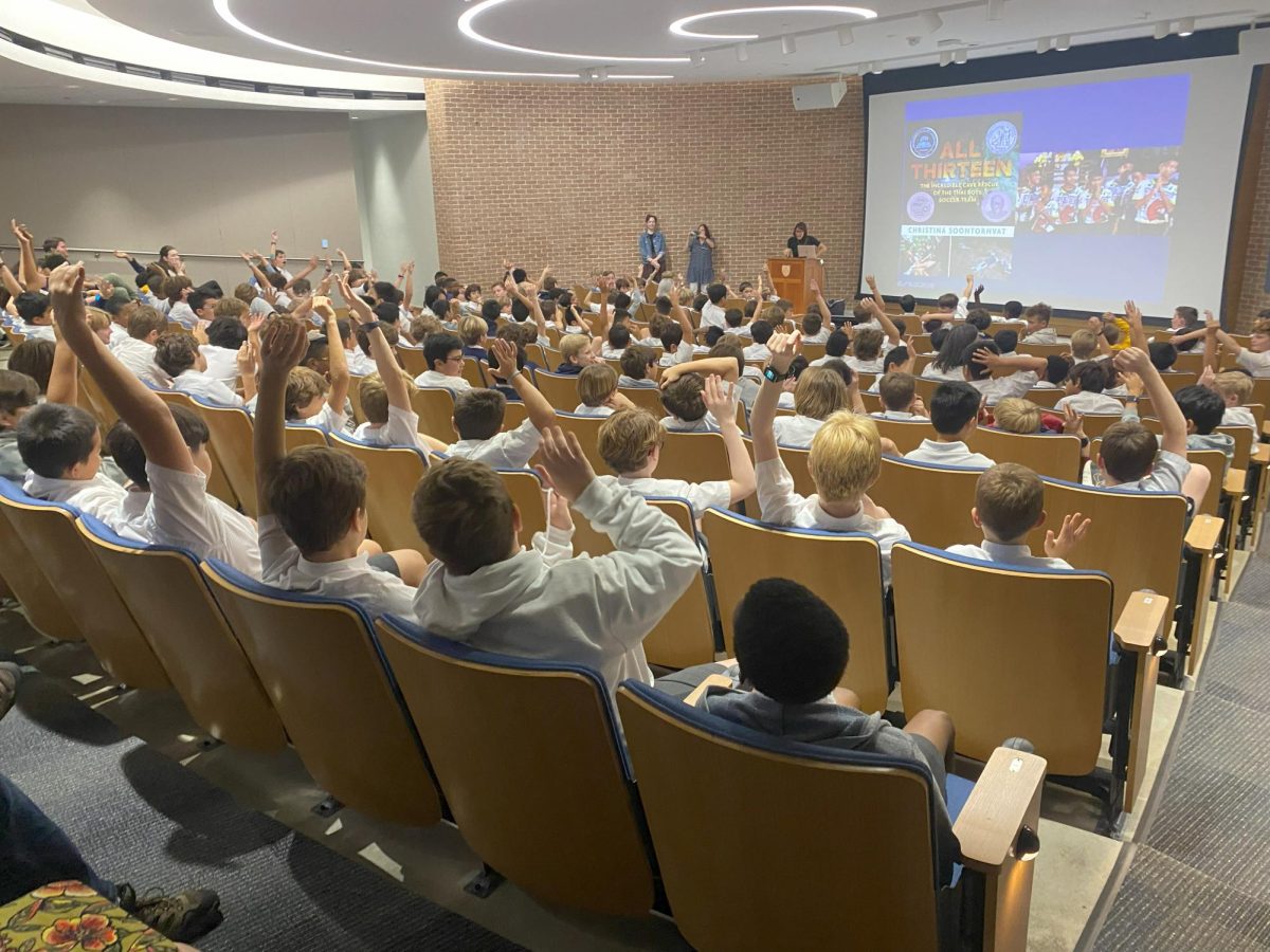 Students eagerly raise their hand during Christina Soontornvats interactive presentation.