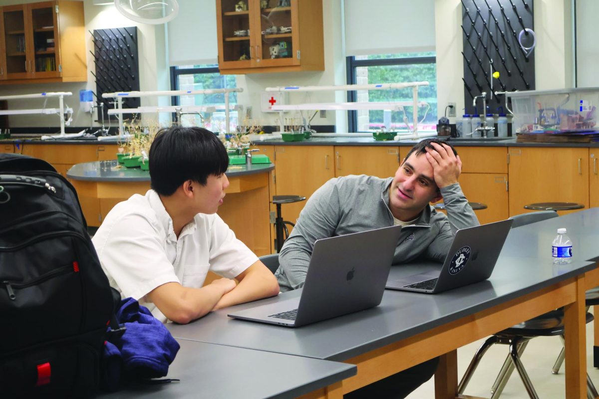 Working in collaboration with Sophomore Richard Wang, Dr. Dan Lipin advises Wang on how to write his scientific paper.