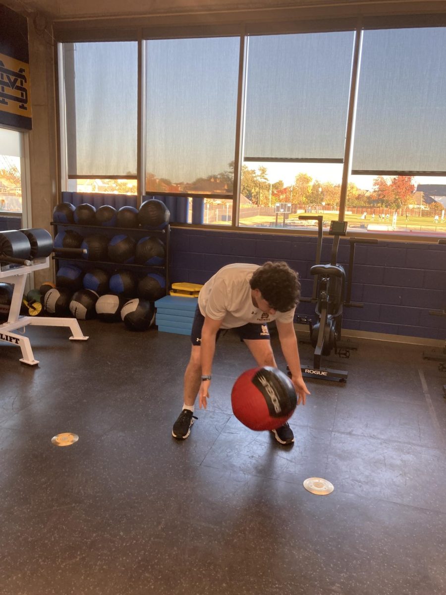 An athlete works out in the weight room. 
