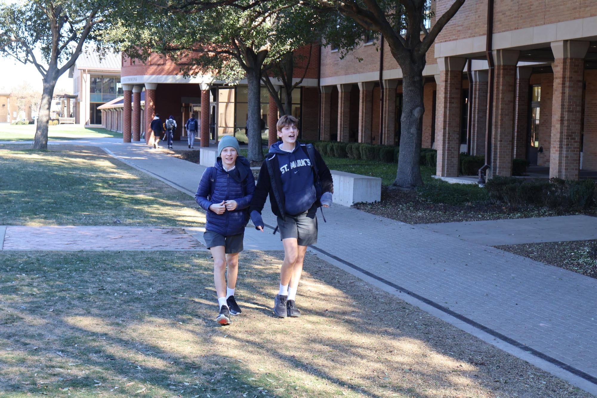 Students walk across the quad in shorts despite the freezing weather.