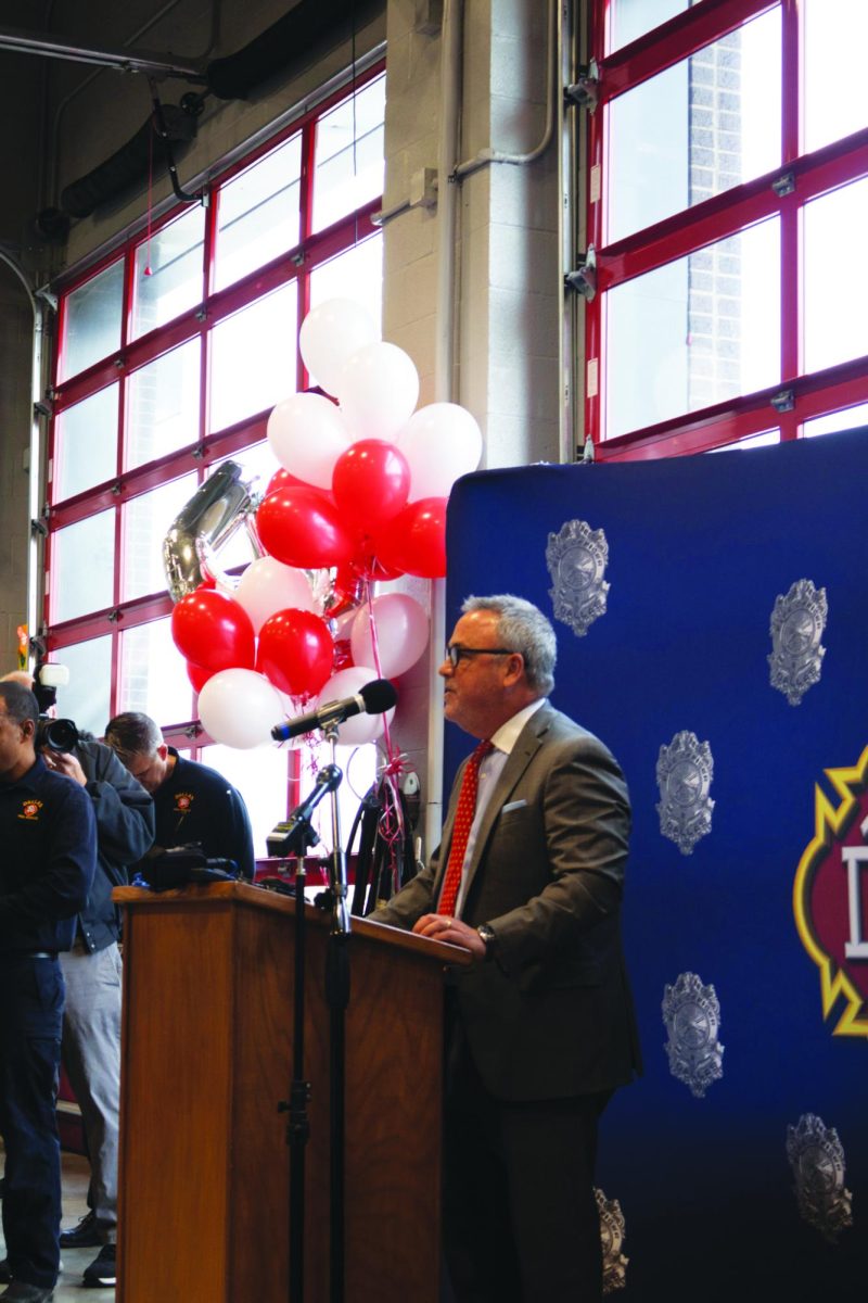Headmaster David Dini delivers the opening prayer during the opening ceremony of Fire Station 41.