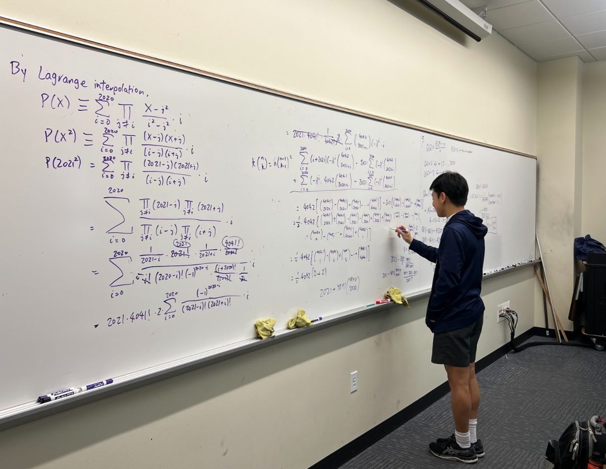Freshman Tony Lu works on a difficult math problem at practice.