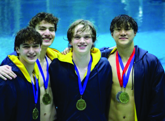 GENERATIONAL The record-breaking relay swim team, pictured from left to right (Adrian Lutgen, Miller Martin, George Hoverman, and Ethan Wang) poses for a picture with their SPC medals. 