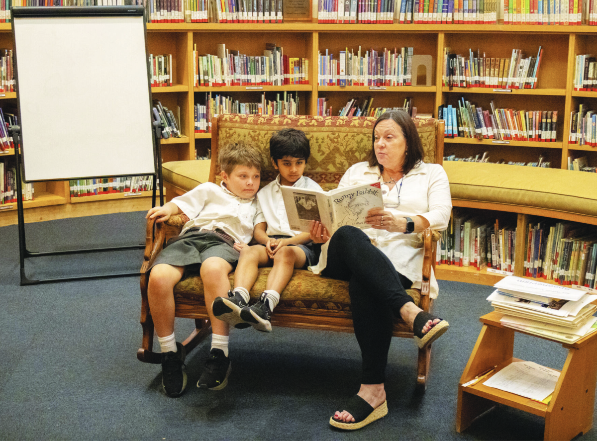 LIBRARY LEARNING Lower School librarian Barbara Kinkead reads to her students.
