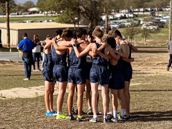 Rising sophomore Harman Pope huddles with his fellow runners