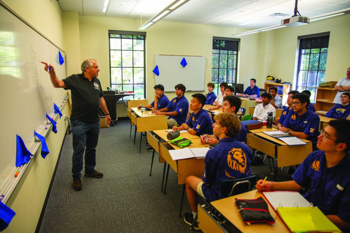 Leader lectures to the Upper School Math Team about a difficult game theory problem