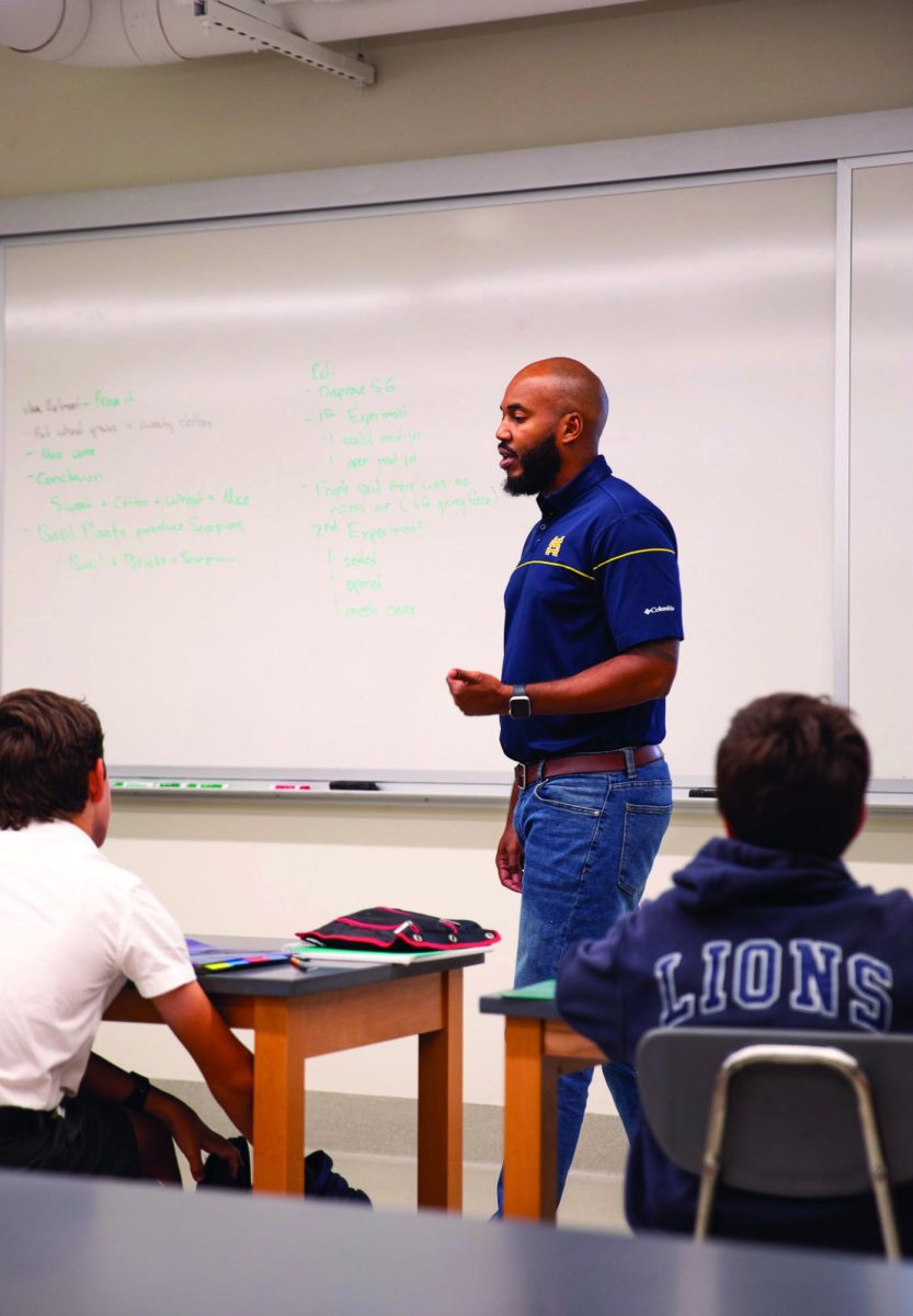 Newly appointed AP Environmental Science teacher Ryan Brewer instructs his ninth grade biology class on Francesco Redi’s experiment.