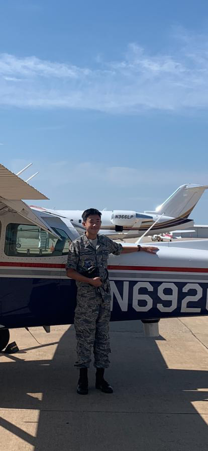 Sumethasorn poses in front of a plane.