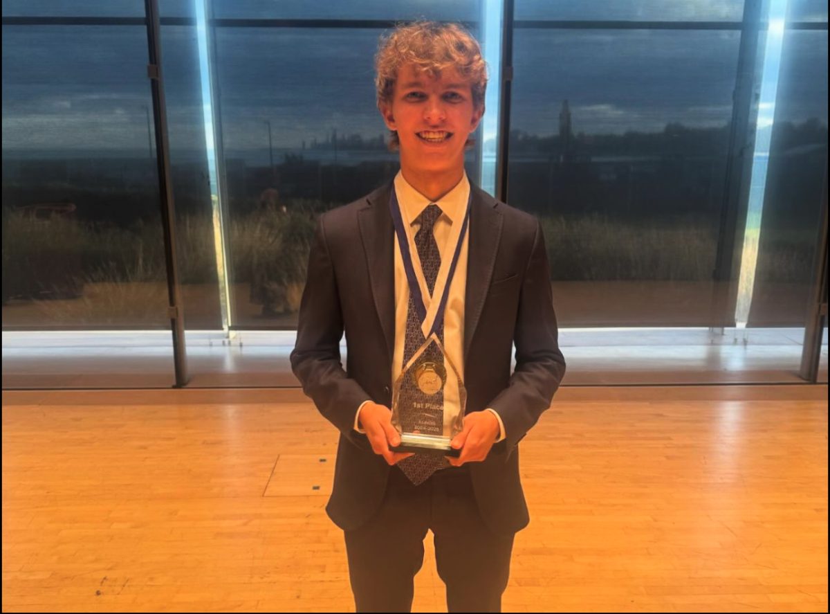 Senior Lukas Palys holds the first-place trophy after winning the competition.