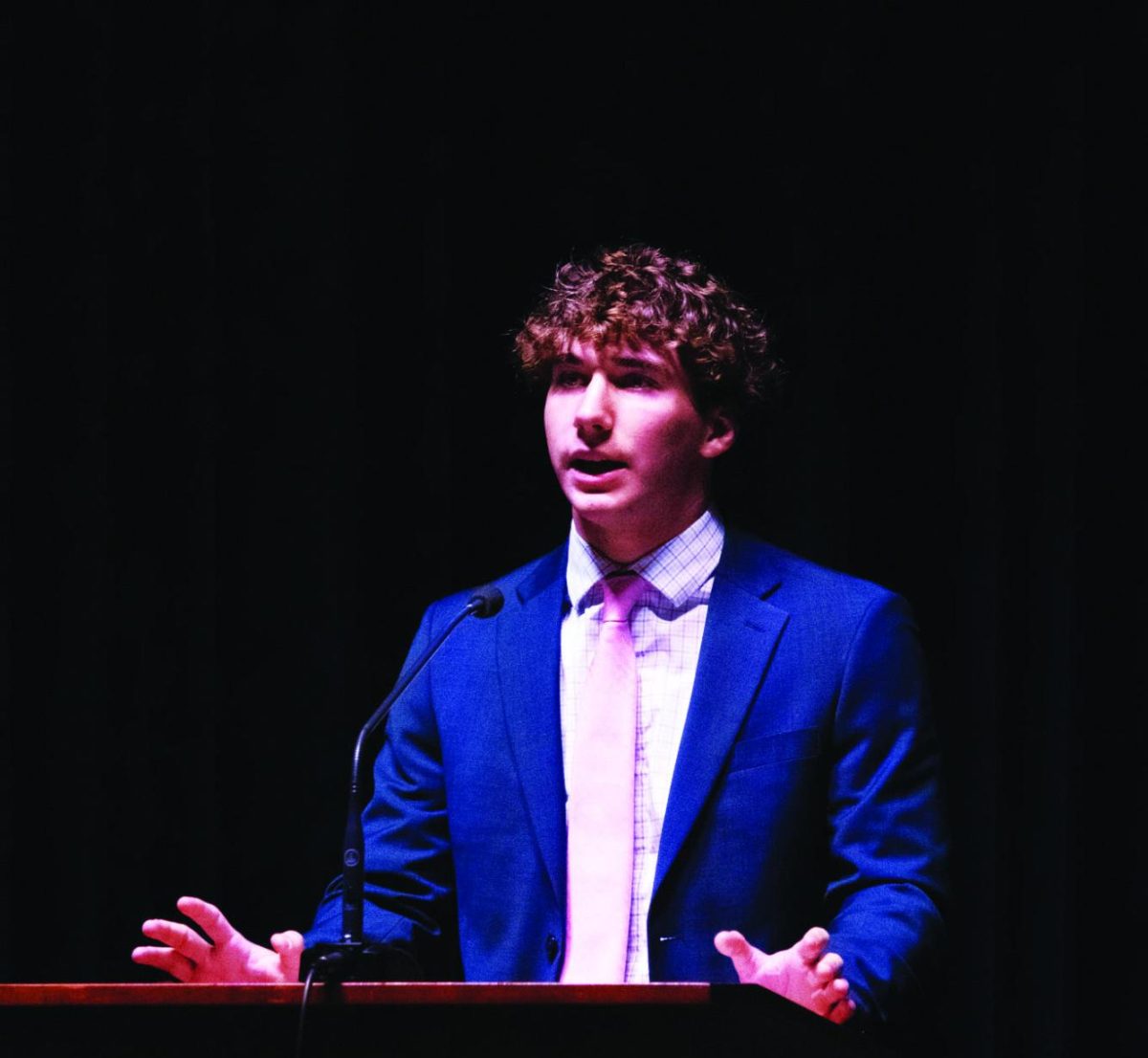 Senior Wyatt Loehr speaks in front of the Upper School about his experience of losing his mother to breast cancer.