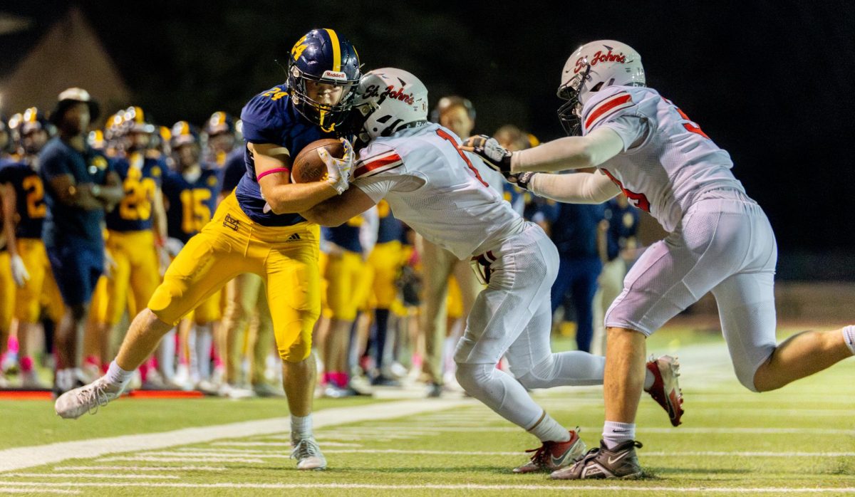 Senior Russell Higgins powers through St. Johns defenders.