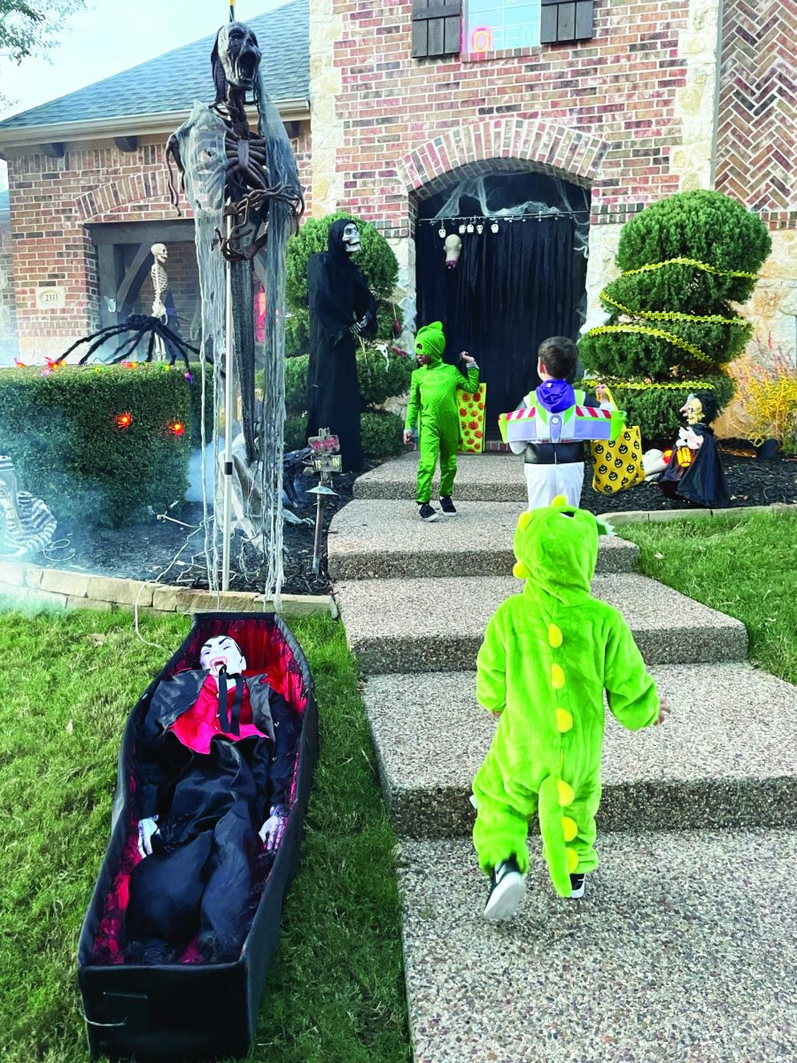 Young children run up to a popular trick-or-treating house.