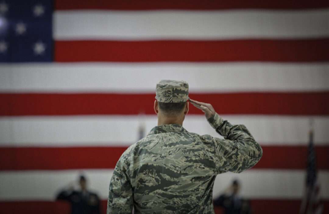 U.S. airmen salutes during an assumption of command ceremony. Original public domain image from Flickr