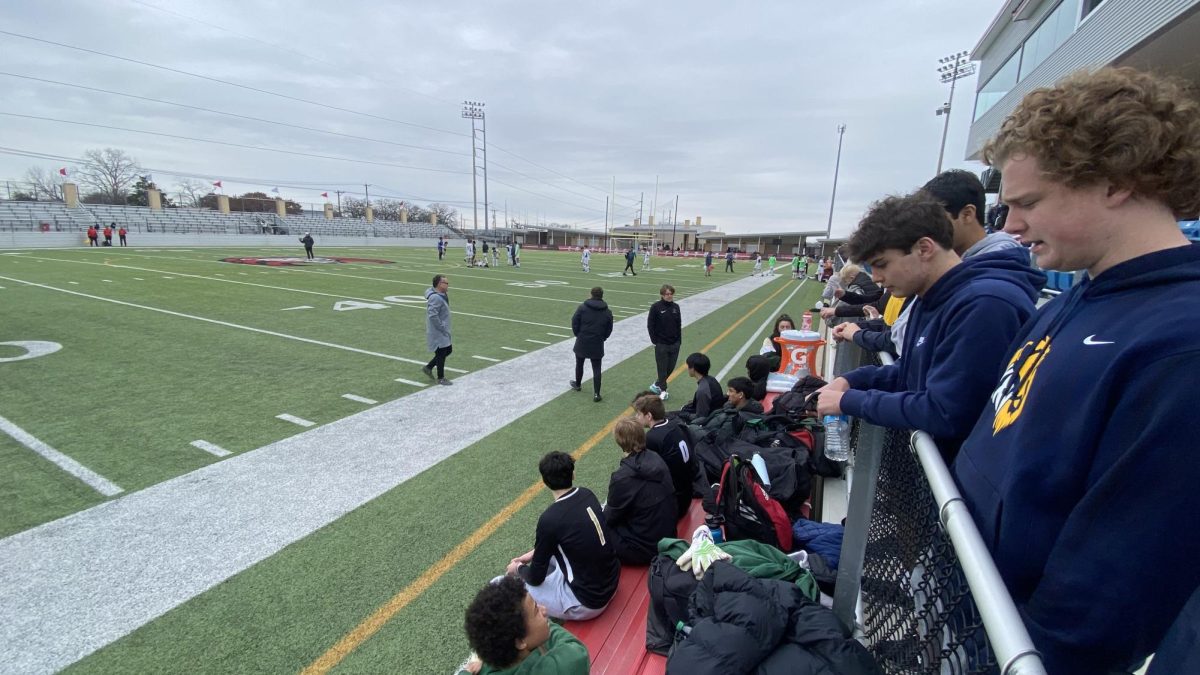 Students watch the extremely close semi-final soccer match