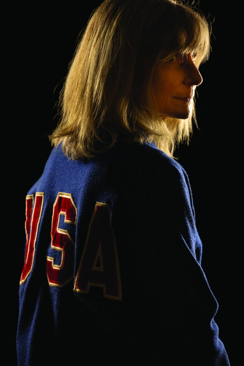 Middle School math instructor Liz Kraft poses for a picture in her Team U.S.A jacket.