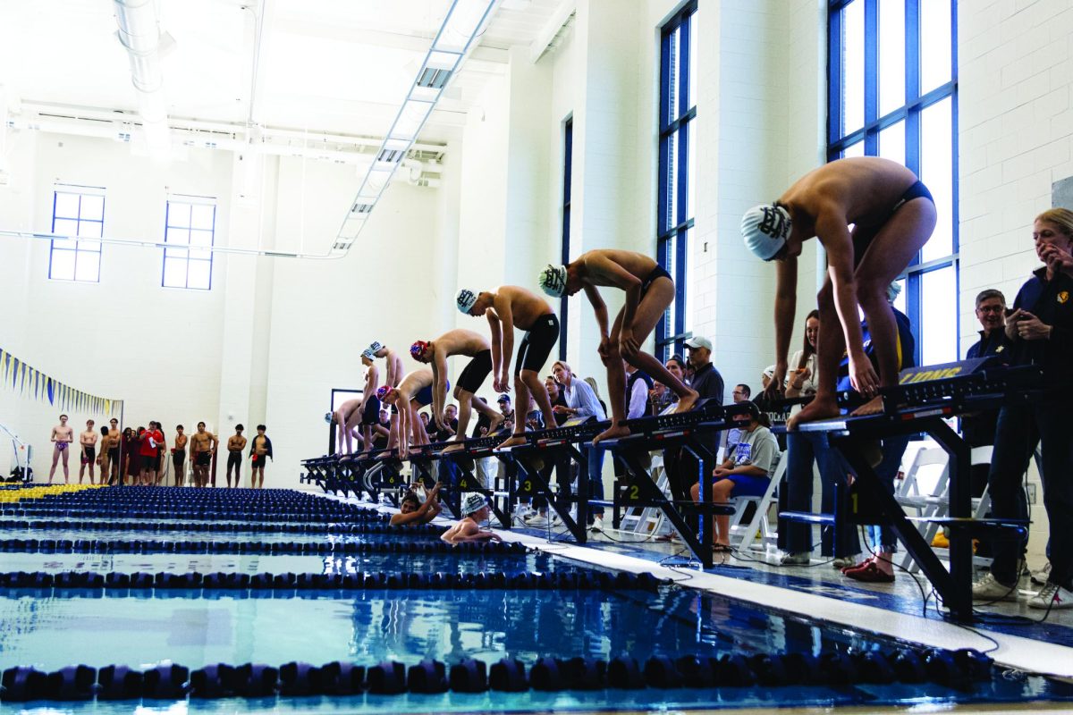 Swimmers prepare to dive into the new Levering Pool for their first ever meet in the Zierk Athletic Center