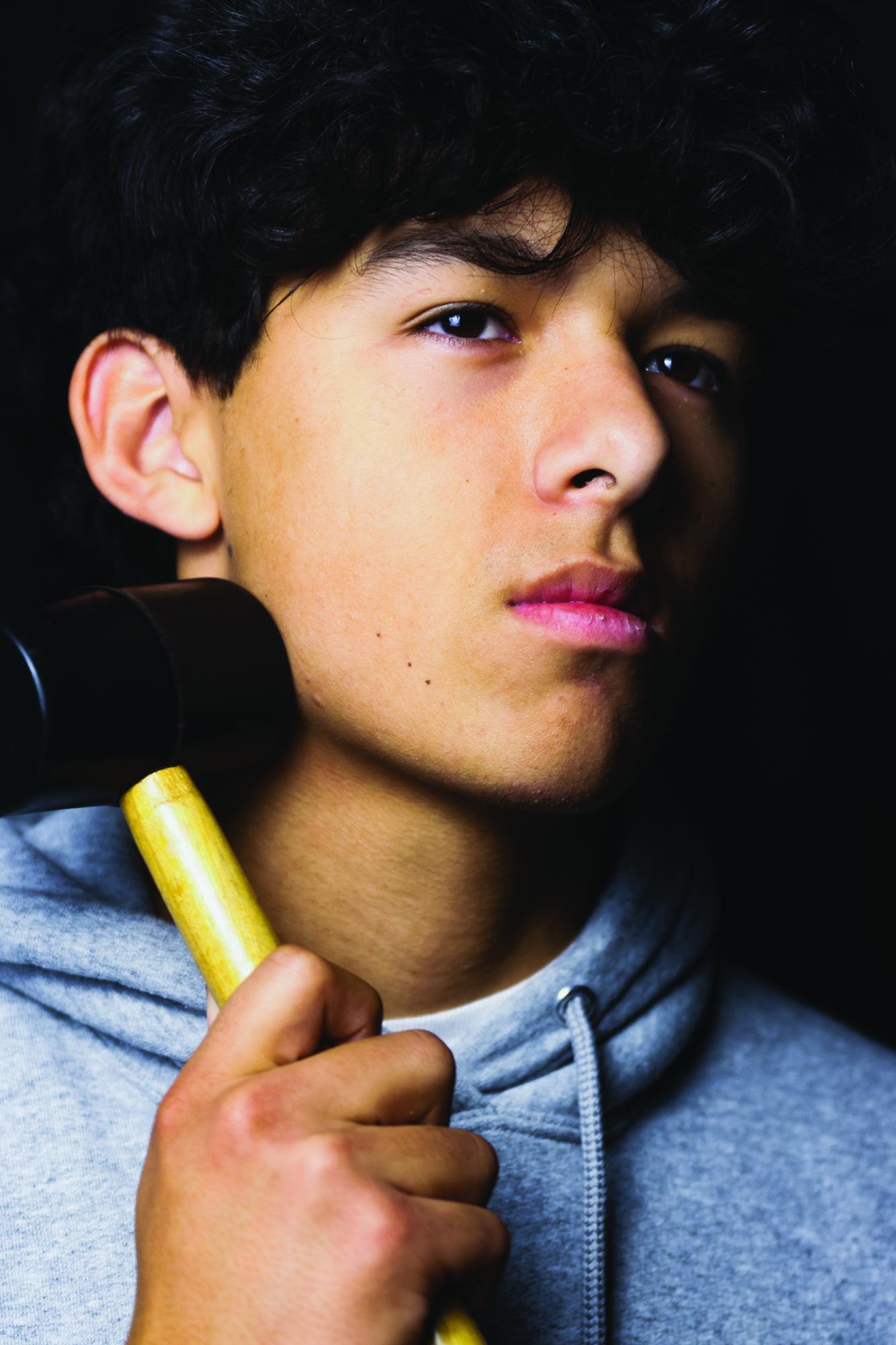 A student holds hammer up to jaw, as practiced in the bonesmashing technique