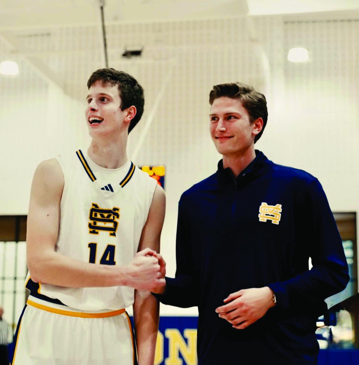 The two brothers celebrate after Luke breaks his brother's record for points in a St. Mark's uniform.