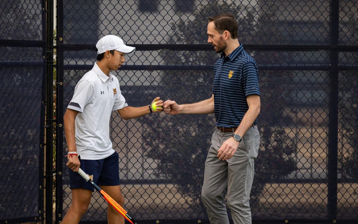 Freshman Bryan Li celebrates with new assistant coach Christian Nagy after winning a point. 