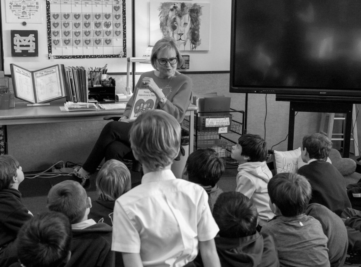 Second grade instructor Susan Morris reads a book out loud to her students.