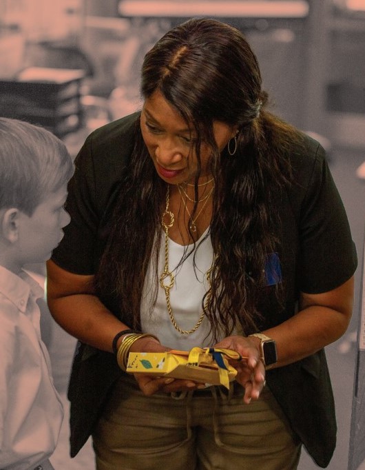 Third grade instructor Tracey McKenzie helps out a Lower School student in the classroom.