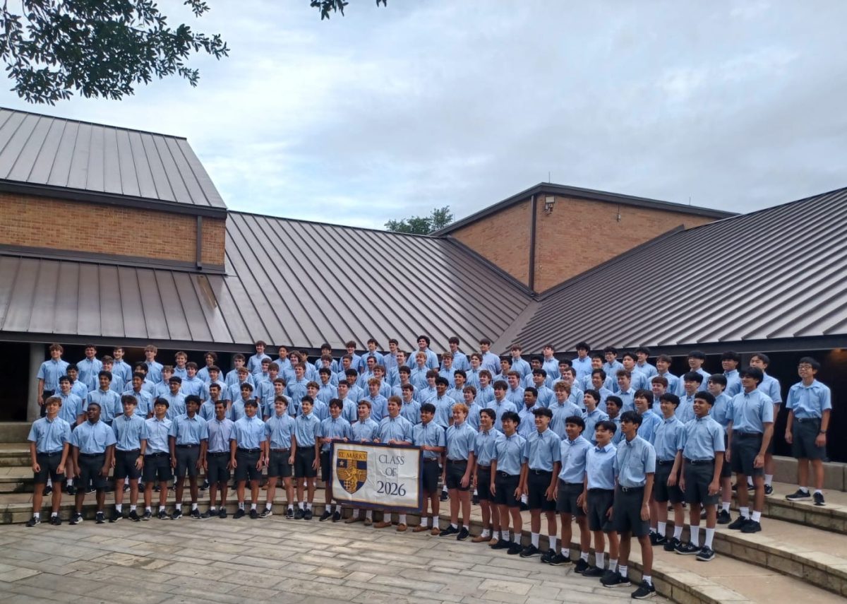 The new senior class poses with their class flag on blue shirt day