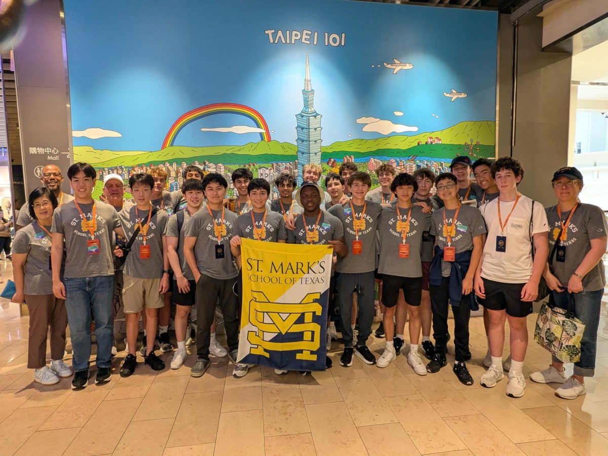 The Marksmen stand with a flag outside of the Taipei 101 building