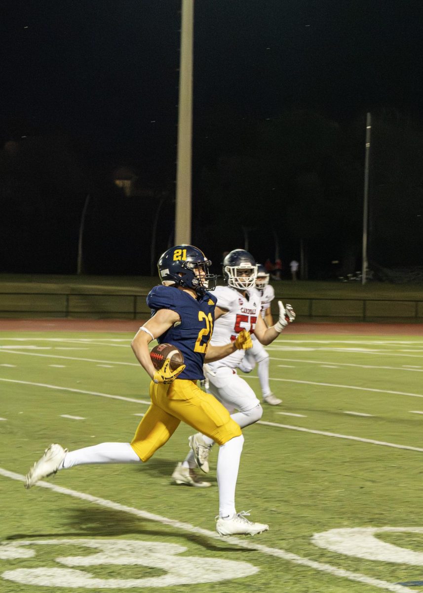 Junior safety Blaine Henley sprints down the field after an interception