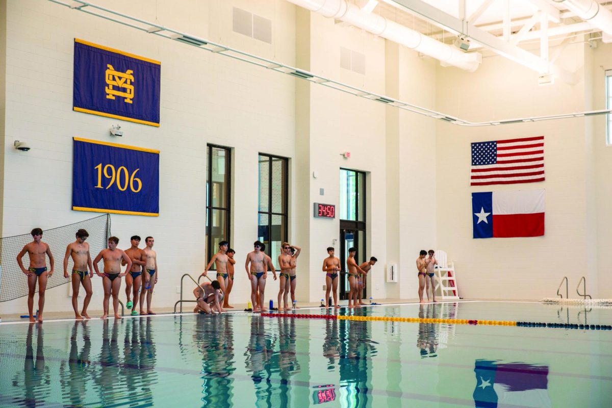 St. Mark’s water polo team members line up on the pool deck before their practice begins.