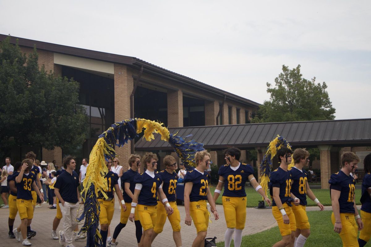 The Lions walk through the Perot Quadrangle for Lion Pride Night
