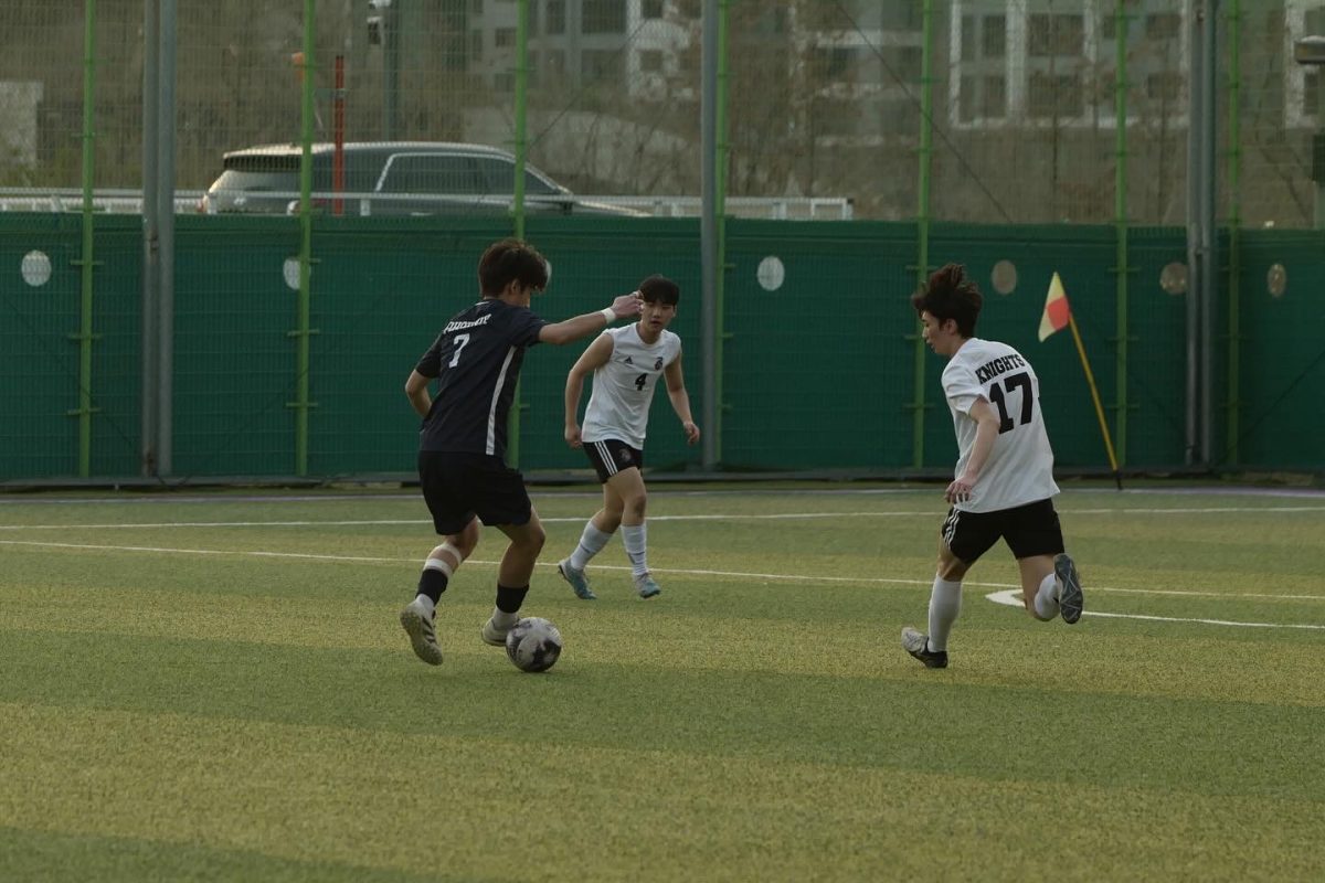 Sophmore Ian Cho facilitates and dribbles around two defenders. 