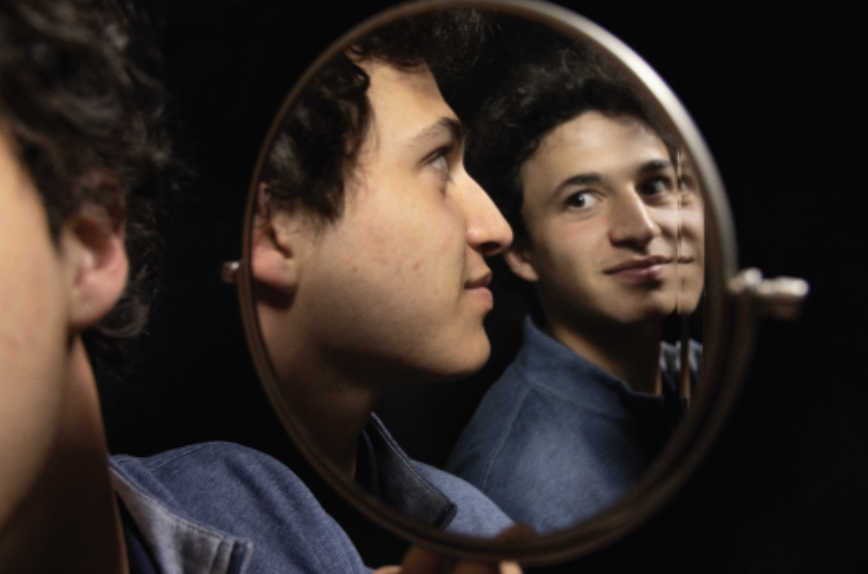 Senior Alex Dahlander looks into a mirror. Reputation often drifts from one’s true image, becoming a blurred reflection. 