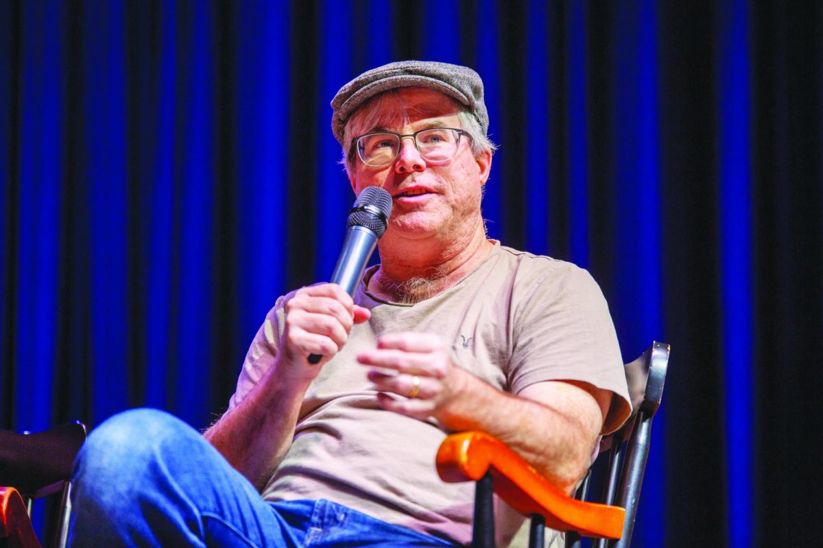 Weir speaks during a panel discussion with three other guest writers in front of the Upper School.