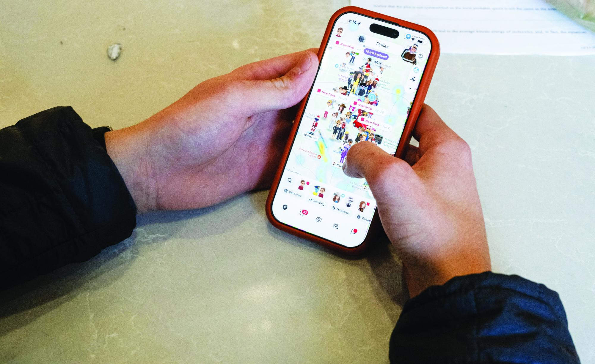 A student checks Snap Map, where many of his friends are sharing their location.