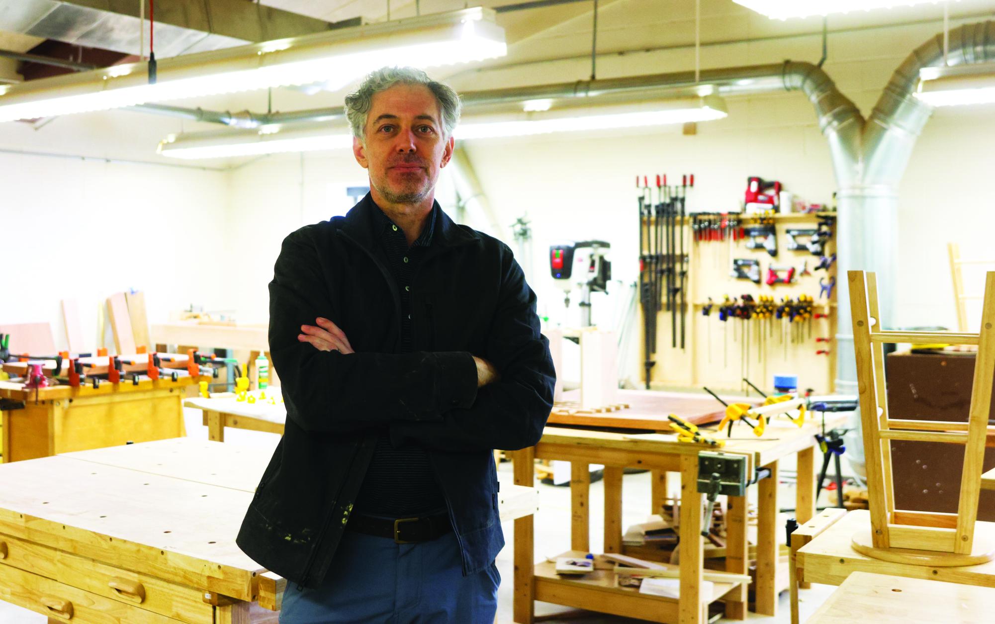 3D-design & woodworking teacher Ryder Richards stands in the workshop where he teaches class.