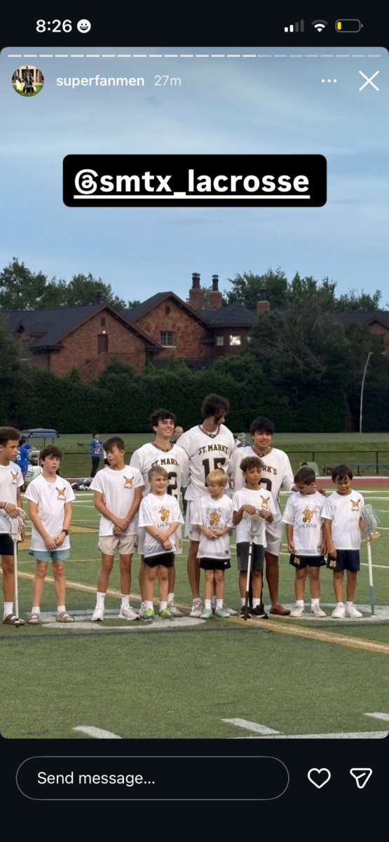 Rocco Renda (left), Weston Chance (center) and Michael Jimenez (right) pose at halftime for a photo with their little buddies.