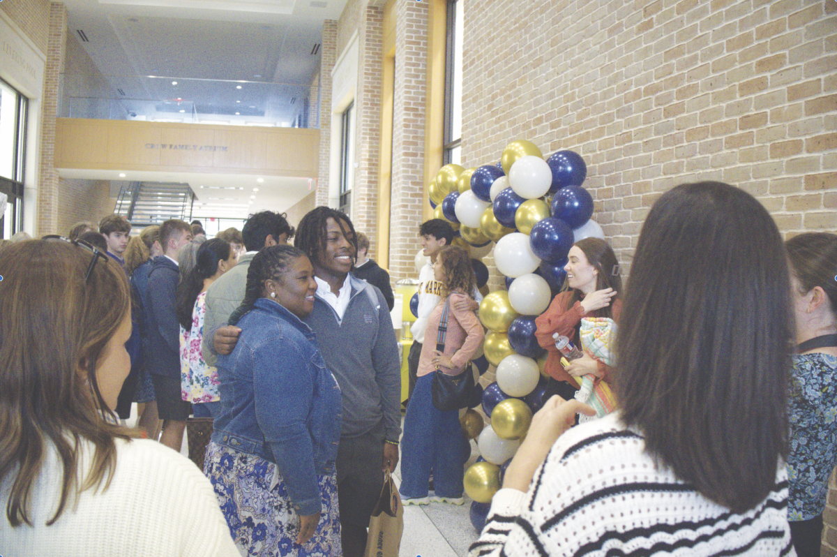 Junior David Dickson and his mother take photos during an annual pinic, filled with homemade dishes and hand crafted 